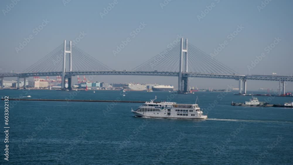 Yokohama, Japan - a ship passes by the Yokohama Bay Bridge Yokohama, Japan - a ship passes by the Yokohama Bay Bridge