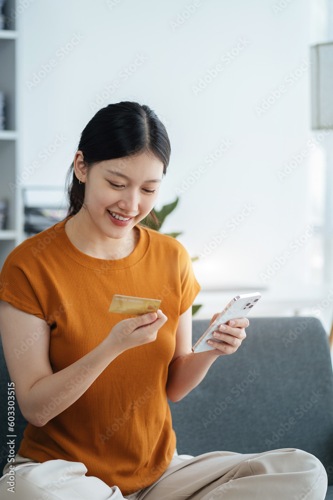 Hands holding credit card and using smartphone in home. Online shopping. Hands holding credit card and using smartphone in home. Online shopping.