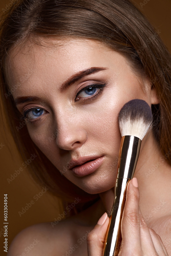 woman applying blush on cheeks with make-up brush woman applying blush on cheeks with make-up brush