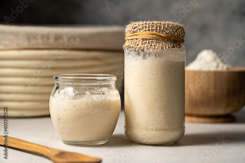 Sourdough starter in jars. Healthy wild fresh homemade yeast for sourdough bread baking. photo