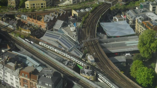 London, UK - a view from The Shard of many train tracks laid over Borough Market. Mulitple trains pass in different directions. photo