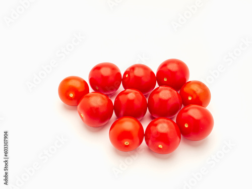 A pile of fresh tomatoes on a white background.
