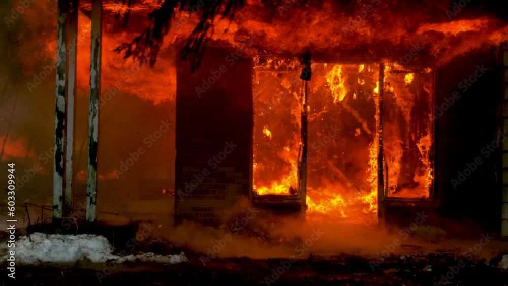 Fire in the house. Burning house slow motion. Flames of fire from of the house. War in Ukraine.