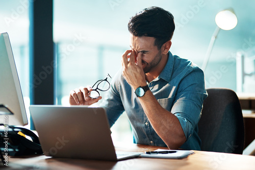 Eye strain, headache and business man at laptop with stress, mental health problem and brain fog. Tired, frustrated and confused worker at computer with fatigue, burnout and pain of vertigo in office photo
