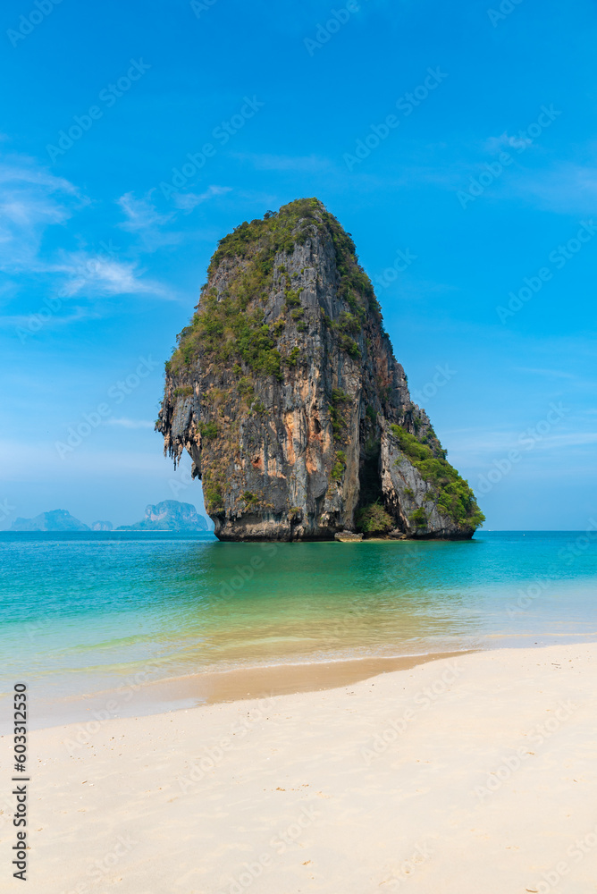 vertical wide angle photo, phra nang beach in Thailand, paradise, sandy shore, sunbathing and swimming in the sea, blue ocean and sky, relaxation and enjoyment
