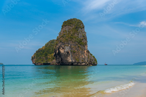 horizontal closeup photo  phra nang beach in Thailand  paradise  sunny beach  sunbathing and swimming in the sea  blue ocean and sky  relaxation and enjoyment  rock koh rang nok
