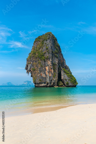 vertical wide angle photo, phra nang beach in Thailand, paradise, sandy shore, sunbathing and swimming in the sea, blue ocean and sky, relaxation and enjoyment © Aleksandr Lavrinenko
