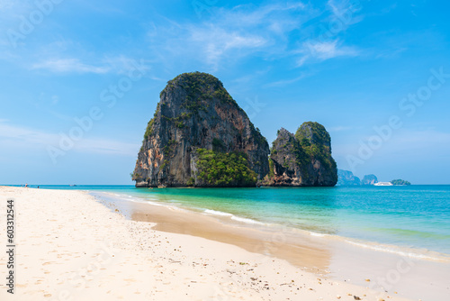 horizontal wide angle photo, phra nang beach in Thailand, paradise, sunny beach, sunbathing and swimming in the sea, blue ocean and sky, relaxation and enjoyment, rock koh rang nok, tourist liner