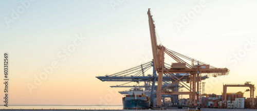 Photography Container cargo ships during unloading at industrial port, import-export logisti