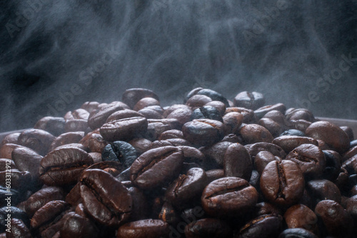 Coffee beans roasting with smoke, selective focus, and soft focus.