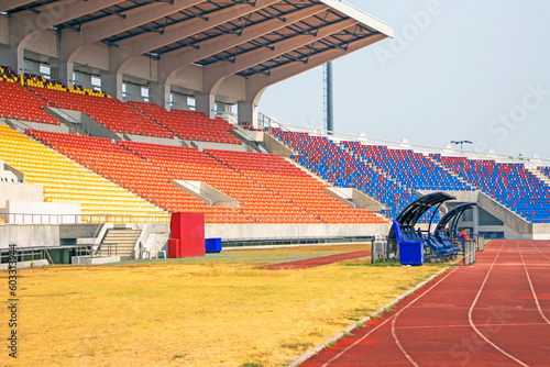 stadium grandstand, sunny weather, blue-red, red yellow seats