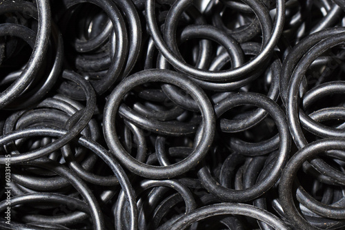 Black hydraulic and pneumatic rubber o-ring seals of different sizes. Spare part gasket