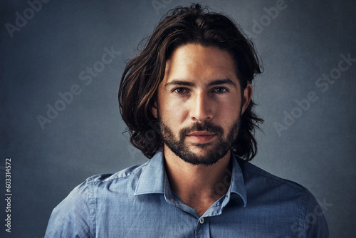 Beard, long hair and portrait of business man with confidence on gray studio background. Face, businessman and model with professional style of entrepreneur, manager or formal corporate worker photo