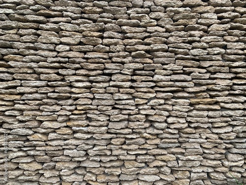 Stone wall made of natural material. Gray bricks are stacked on top of each other. Background texture: masonry concrete wall.
