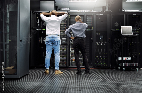 Server room, it support or electrician fixing a problem for hardware maintenance or stressful glitch crisis. Confused or back of worried technicians or electrical engineers in information technology