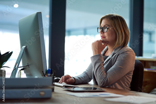 Computer, thinking and business woman in office working late on project at night alone. Desktop, professional and female person problem solving, focus or solution, planning or reading on deadline