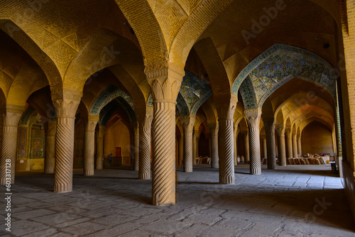  Vakil  mosque praying hall with spiral pillars of stones and roof tiling illuminated with sunlight located in Shiraz  Iran
