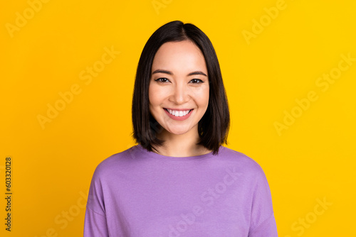 Photo of adorable good mood girl with bob hairdo dressed violet shirt smiling at camera dental ad isolated on yellow color background