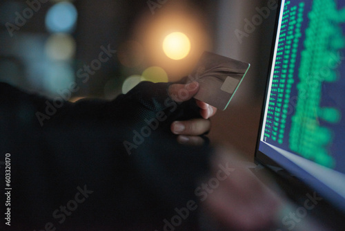 Theft, hands of a hacker with credit card with a laptop and screen of numbers. Illegal or money laundering payments, cyber security and male person stealing capital from account with online software photo