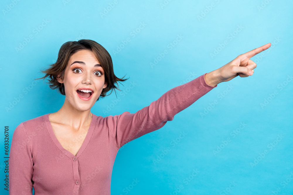 Photo of charming excited lady traveler showing museum way direction tourist wear pink shirt isolated blue color background Photo of charming excited lady traveler showing museum way direction tourist wear pink shirt isolated blue color background