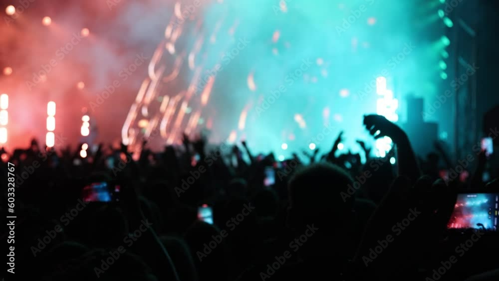 Crowd of Fans Waving Hands, Enjoying Live Music Group Performing on Illuminated Concert Stage, Cinematic Slow Motion Crowd of Fans Waving Hands, Enjoying Live Music Group Performing on Illuminated Concert Stage, Cinematic Slow Motion