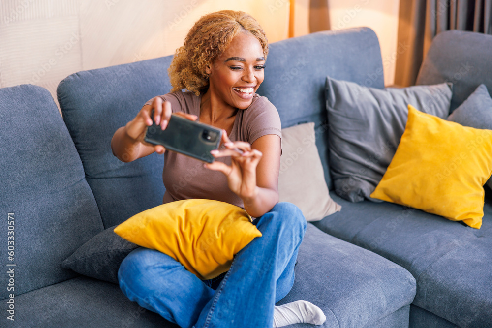 Woman taking selfies while spending leisure time at home