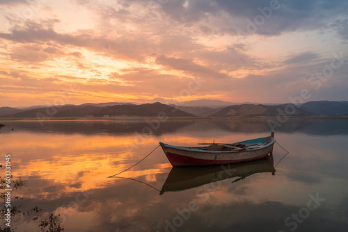 beautiful landscape with a boat and the sun