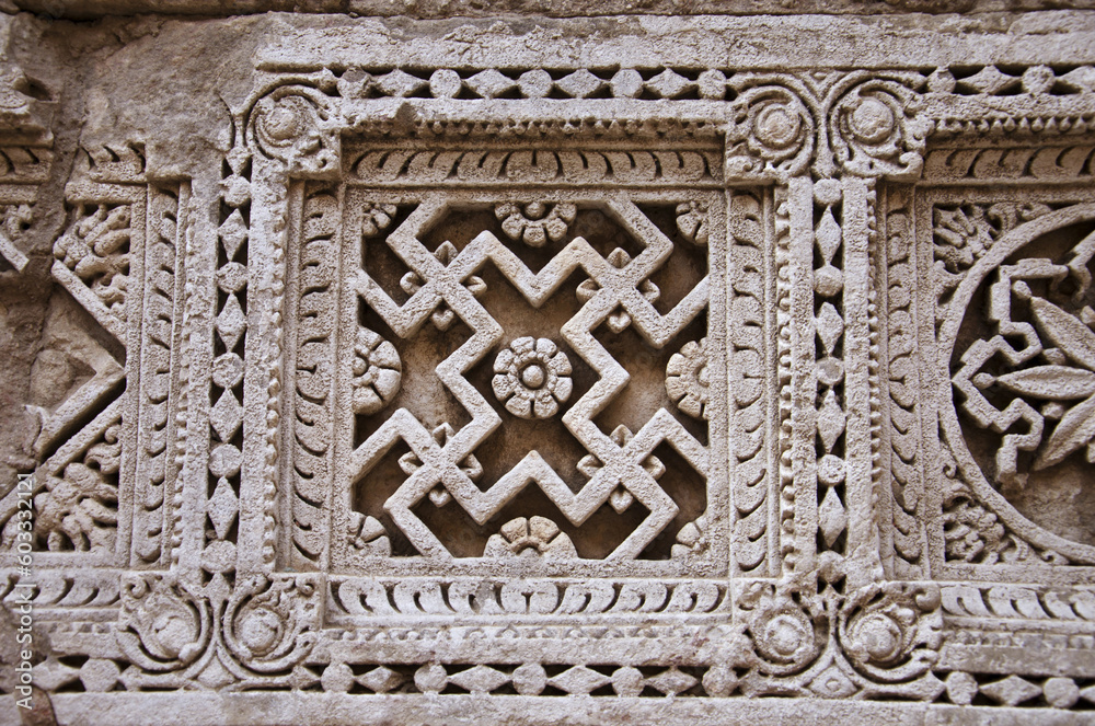 Carved Patola (Double Ikat) pattern on the inner wall of Rani ki vav, an intricately constructed stepwell on the banks of Saraswati River. Patan in Gujarat, India.