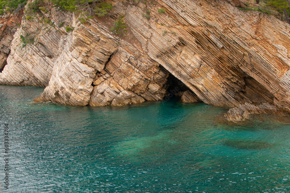 Rock cave on coastaline. Summer beauty of adriatic seaside nature.