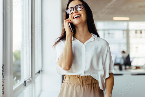 Female business professional speaking on the phone in an office