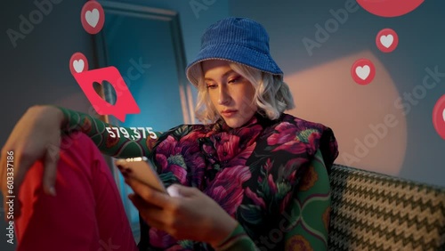 Blonde young trendy woman using her phone to interact with social media, getting followers, likes, emoji feedback