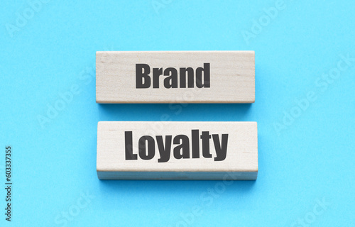 Brand Loyalty words on wooden blocks and blue background.