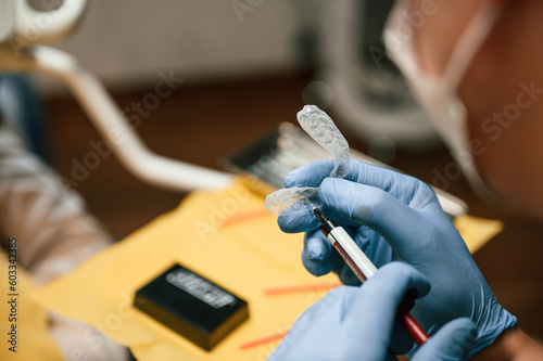 The aligner. Close up view of dentist equipment. Doctor with gloves © standret