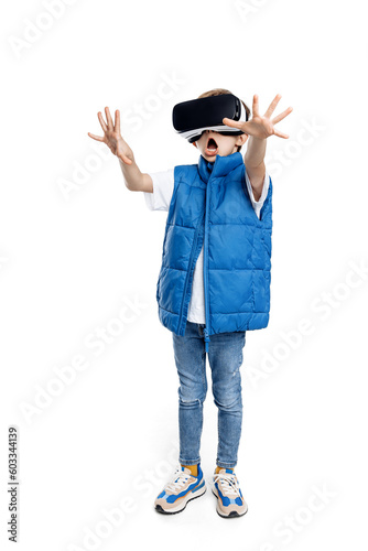 Full lengh image of screaming little kid wearing modern goggles of virtual reality on bright white backdrop. photo