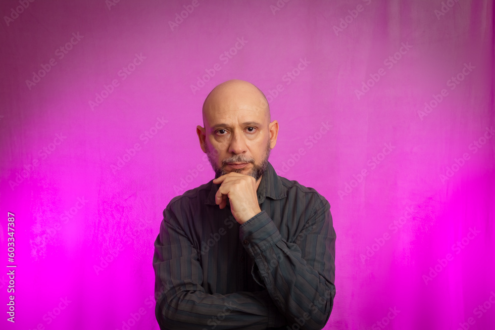 Portrait of a serious 50-year-old man with a beard and bald head. Portrait of a serious 50-year-old man with a beard and bald head.
