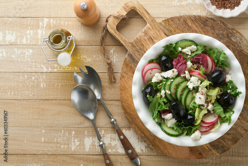 Lettuce salad, cucumber, radish salad with cottage cheese and flax seeds olive oil salad on old wooden background. Healthy diet food. Diet menu and balanced diet. Top view.