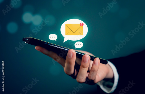 Businessman hand using smartphone and shows a digital screen of new email notifications, messages to deliver.