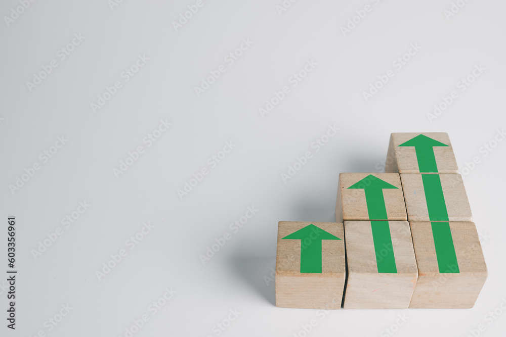 Goal and Achievement in business concept.,Green Arrow up icon on wooden cubes stack as stair over white background suitable for Growth,success,target idea.