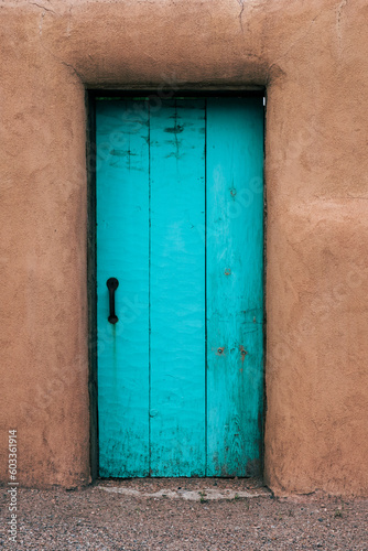 Adobe House with Turquoise Door Entrance © Adrinson