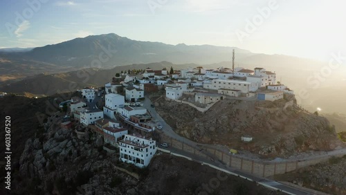 Aerial drone shot of a classic white Andalusian village Comares located on a mountain top near Malaga. photo