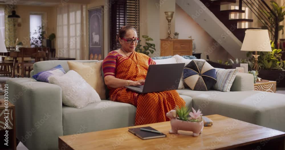 Elderly Indian Woman Using Laptop at Home: Enhancing Her Culinary Skills with Online Cooking Classes, Exploring New Recipes, Sharing Family Traditions. Granmother Eperiences Joy of Learning, Creating Elderly Indian Woman Using Laptop at Home: Enhancing Her Culinary Skills with Online Cooking Classes, Exploring New Recipes, Sharing Family Traditions. Granmother Eperiences Joy of Learning, Creating