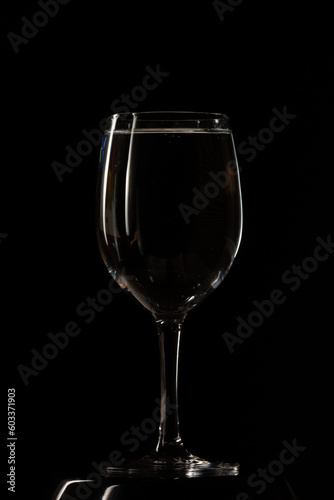 Glass with water on black background