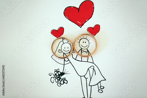 Foto Wedding rings placed on the faces of bride and groom illustration