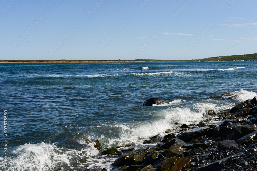 Sea with waves from the seaside in a sunny day against blue sky. High quality photo