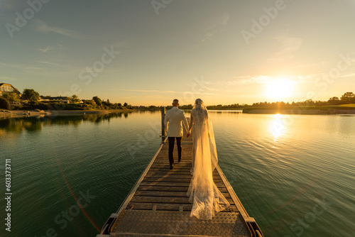 Wedding couple on wooden boardwalk photo