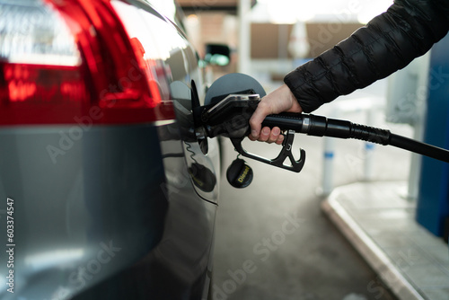 Fuel nozzle filling up car with fuel