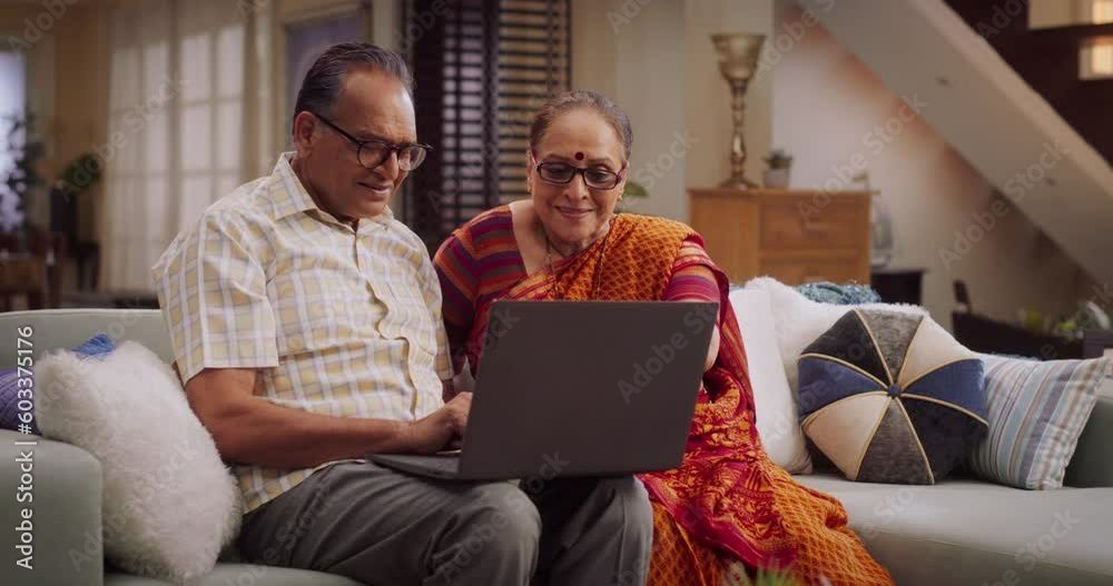 Elderly Couple Using Laptop at Home: Collaborating on Projects, Researching, and Engaging in Lifelong Learning. Nurturing Their Curiosity and Intellectual Growth. Medium Shot.