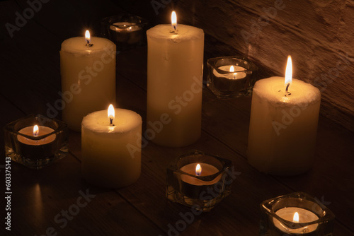photo of burning candles of different sizes