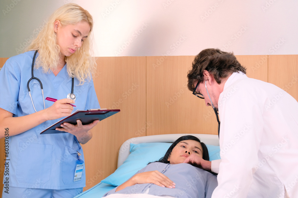 Fototapeta premium A doctor is examining a patient lying on the bed.