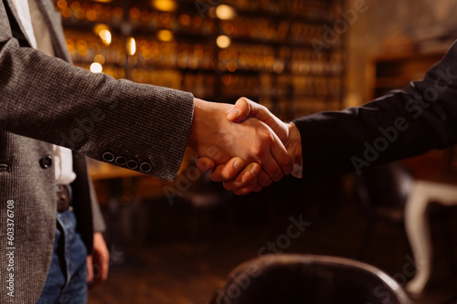 close up.handshake of two business people meeting of friends, business partners. men shaking hands in an evening